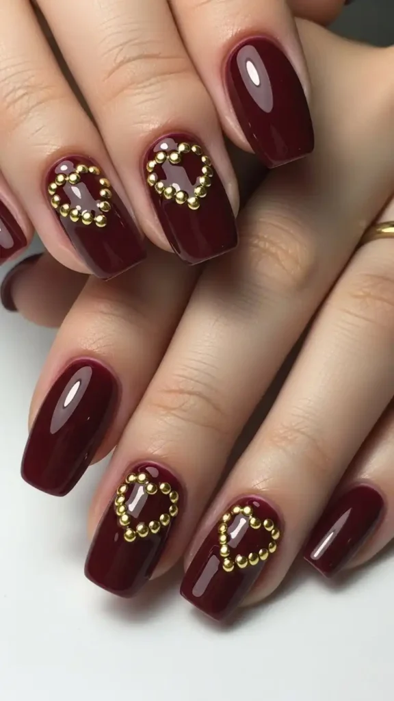 deep-burgundy-nails-with-gold-studs
